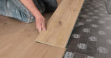man laying SPC hybrid flooring