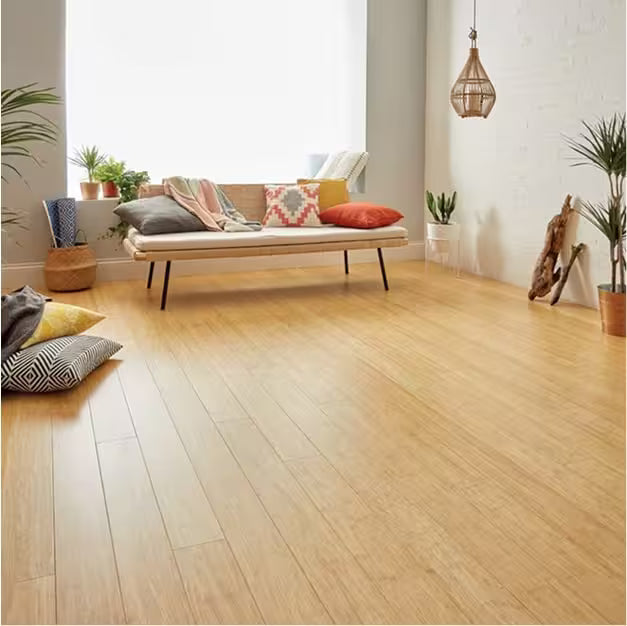 Living room with wooden floor, sofa, and decorative pillows.