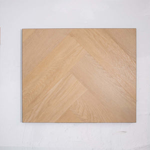 Flat lay of French Oak SPC Hybrid Floorboards Herringbone 7.5+2mm in French Oak colour warm tone herringbone flooring sample