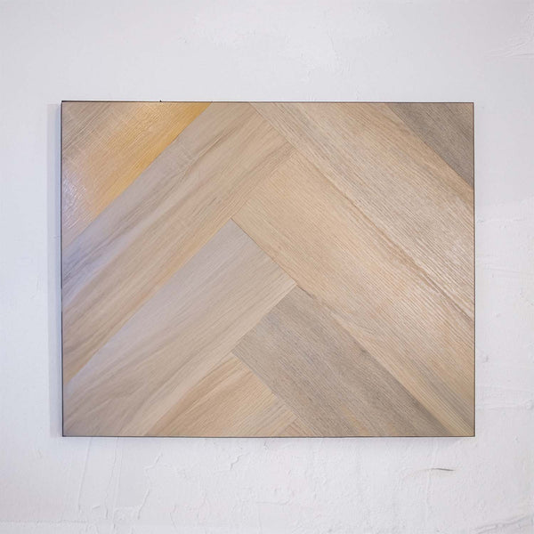 Angled view of Lime Ash SPC Hybrid Floorboards Herringbone 7.5+2mm in Lime Ash colour neutral tone herringbone flooring sample