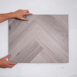 Top-down view of Snow Grey SPC Hybrid Floorboards Herringbone 7.5+2mm in Snow Grey colour light tone herringbone flooring sample