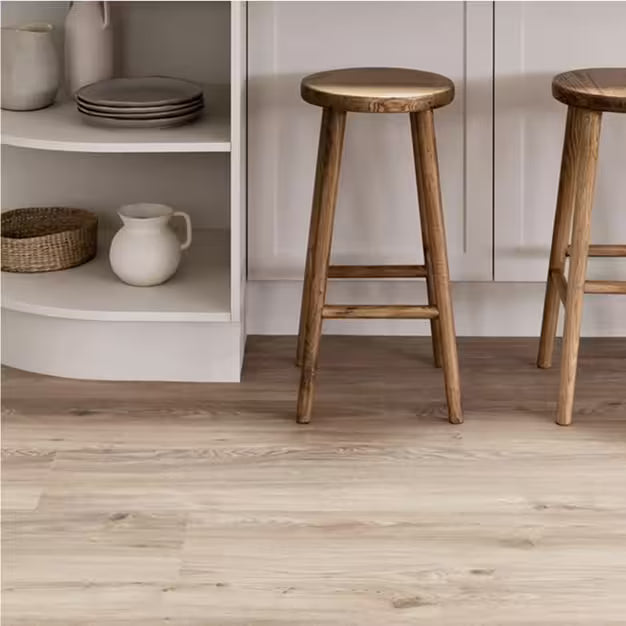 Two wooden bar stools in a room with a shelf containing ceramic items.