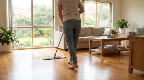 Damp-mopping a warm honey oak engineered timber floor with a microfibre mop