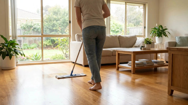 Damp-mopping a warm honey oak engineered timber floor with a microfibre mop