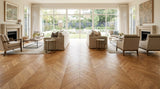 Chevron-pattern engineered oak flooring in a bright modern Australian living room