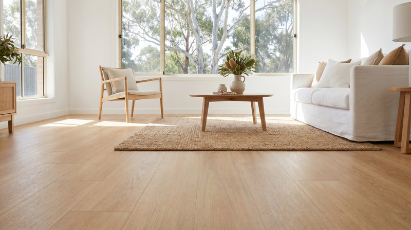 Sunlit Australian living room with pale honey-blonde blackbutt hybrid flooring
