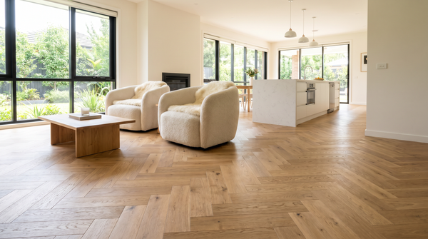 Open-plan Australian living space with natural oak herringbone hybrid flooring