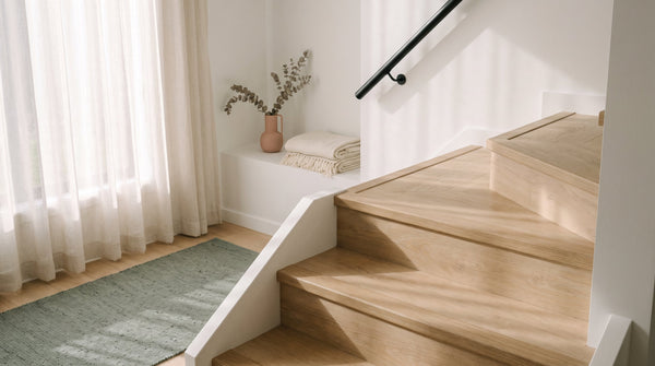 Staircase treads finished in pale oak hybrid flooring with colour-matched stair nosing along each front edge