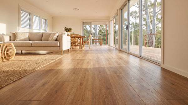 Urban Laminate 12mm in a warm oak tone running through an open plan Australian living and dining room in morning light