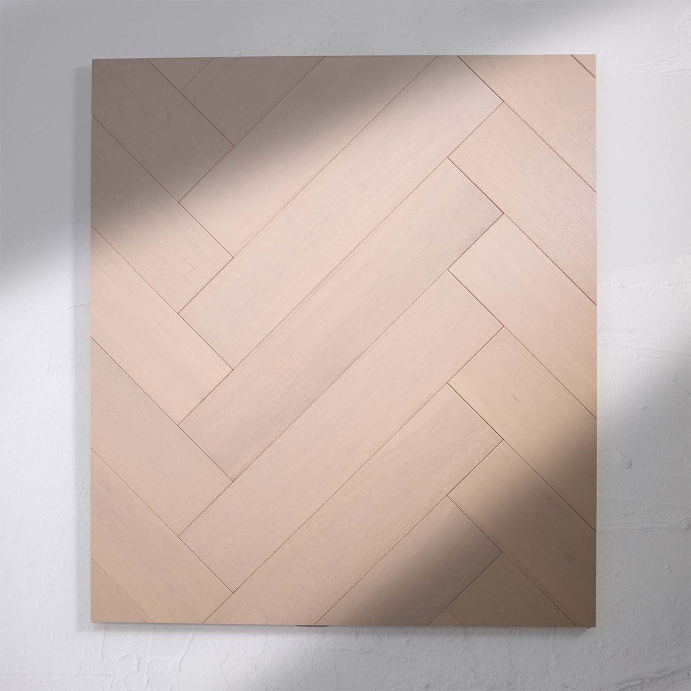 Detailed view of Casper White Engineered Timber Herringbone 15.3mm in Casper White colour light tone herringbone flooring sample