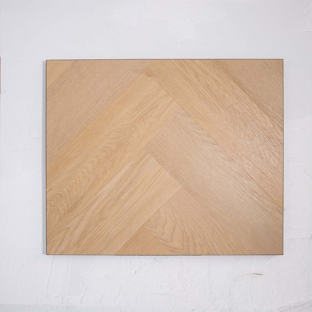 Flat lay of French Oak SPC Hybrid Floorboards Herringbone 7.5+2mm in French Oak colour warm tone herringbone flooring sample