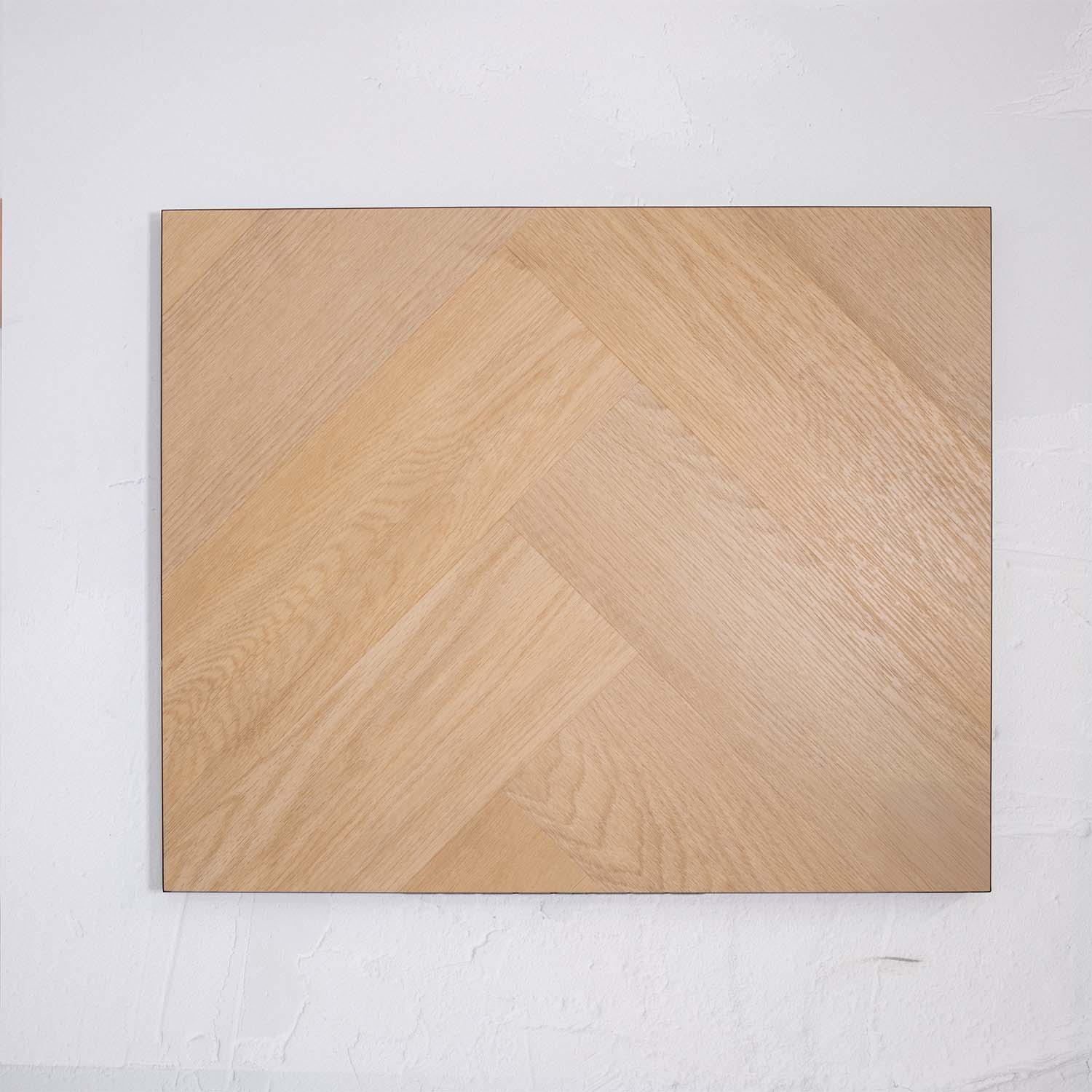 Flat lay of French Oak SPC Hybrid Floorboards Herringbone 7.5+2mm in French Oak colour warm tone herringbone flooring sample