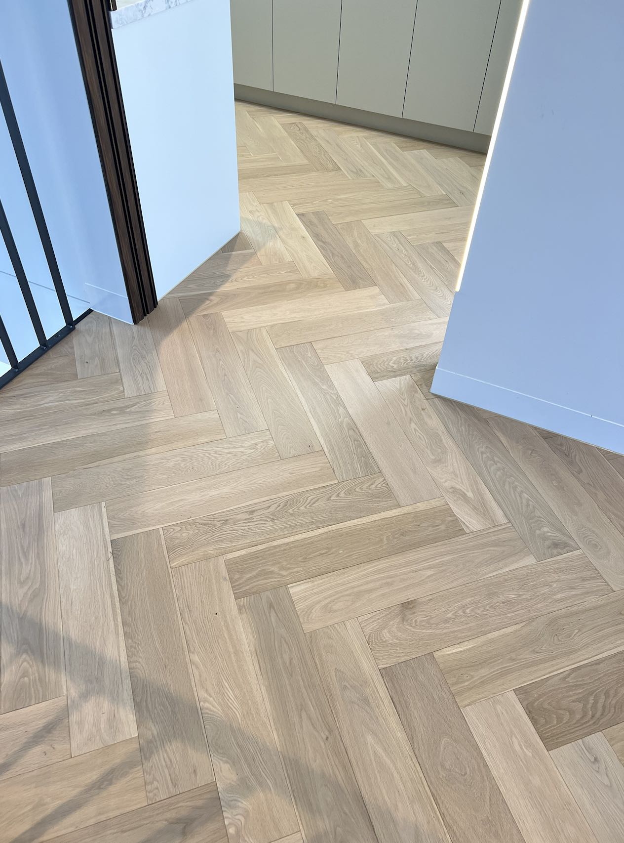 Light coloured herringbone flooring