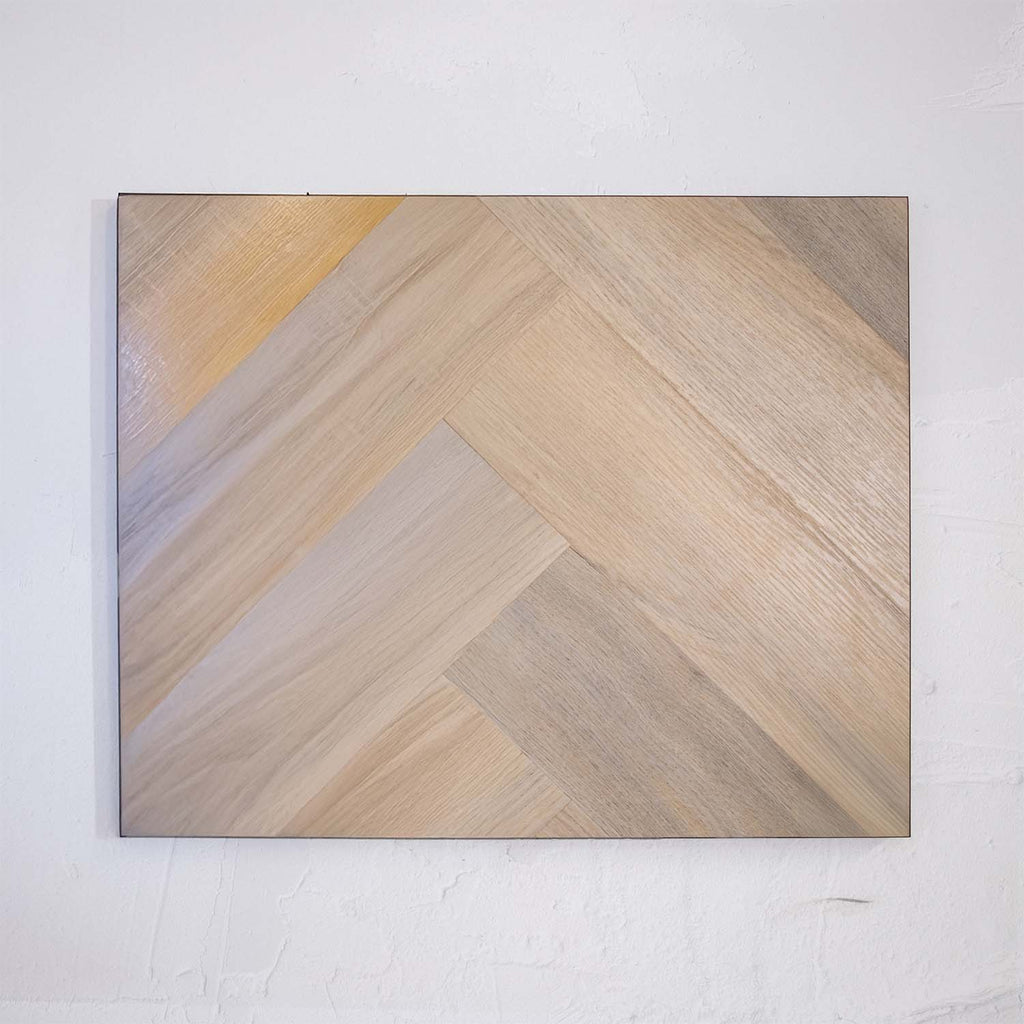 Angled view of Lime Ash SPC Hybrid Floorboards Herringbone 7.5+2mm in Lime Ash colour neutral tone herringbone flooring sample