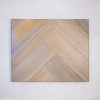 Angled view of Lime Ash SPC Hybrid Floorboards Herringbone 7.5+2mm in Lime Ash colour neutral tone herringbone flooring sample