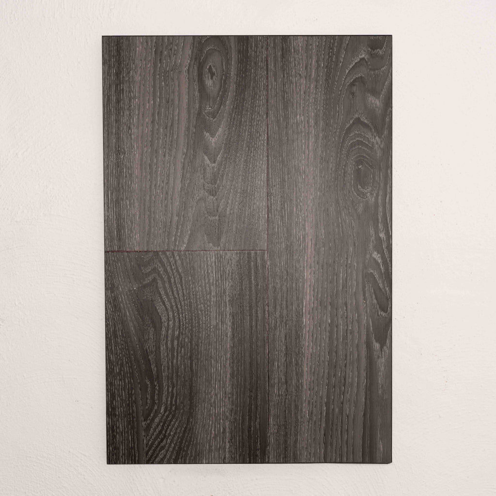 Flat lay of Midnight Oak Sterling Vinyl Plank 1220x229x3mm in Midnight Oak colour dark shade vinyl flooring plank sample