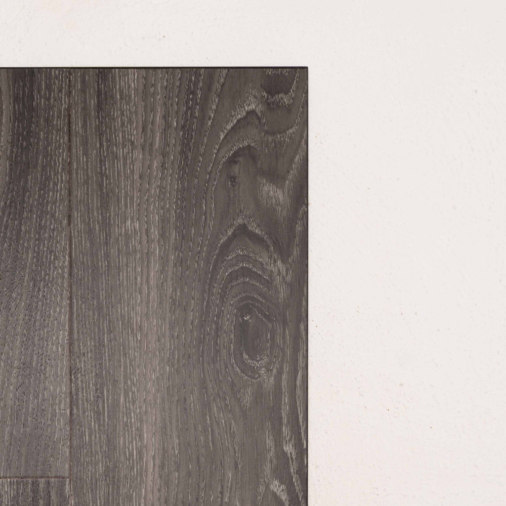 Angled view of Midnight Oak Sterling Vinyl Plank 1220x229x3mm in Midnight Oak colour dark shade vinyl flooring plank sample