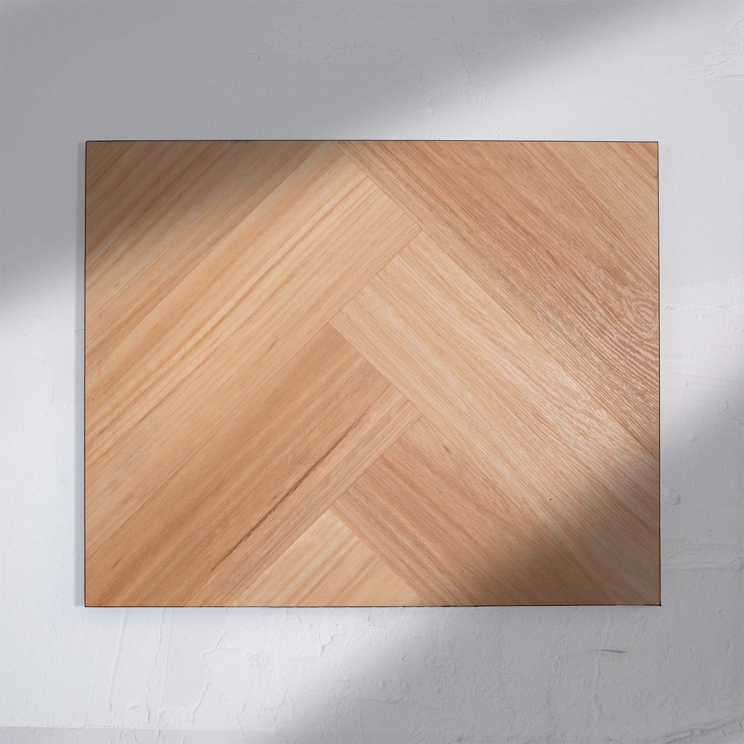 Top-down view of Natural Blackbutt SPC Hybrid Floorboards Herringbone 7.5+2mm in Natural Blackbutt colour dark shade herringbone flooring sample