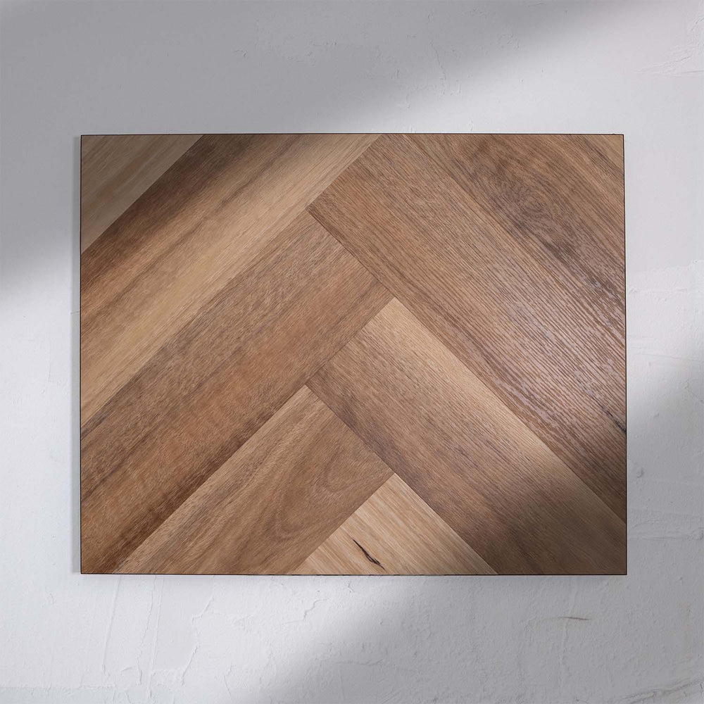Front view of Natural Spotted Gum SPC Hybrid Floorboards Herringbone 7.5+2mm in Natural Spotted colour warm tone herringbone flooring sample