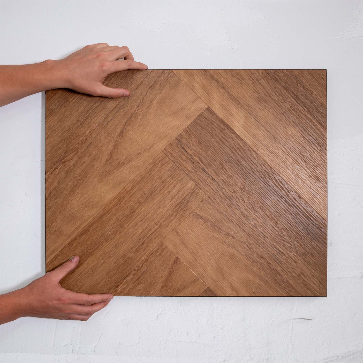 Top-down view of Pacific Spotted Gum SPC Hybrid Floorboards Herringbone 7.5+2mm in Pacific Spotted colour warm tone herringbone flooring sample