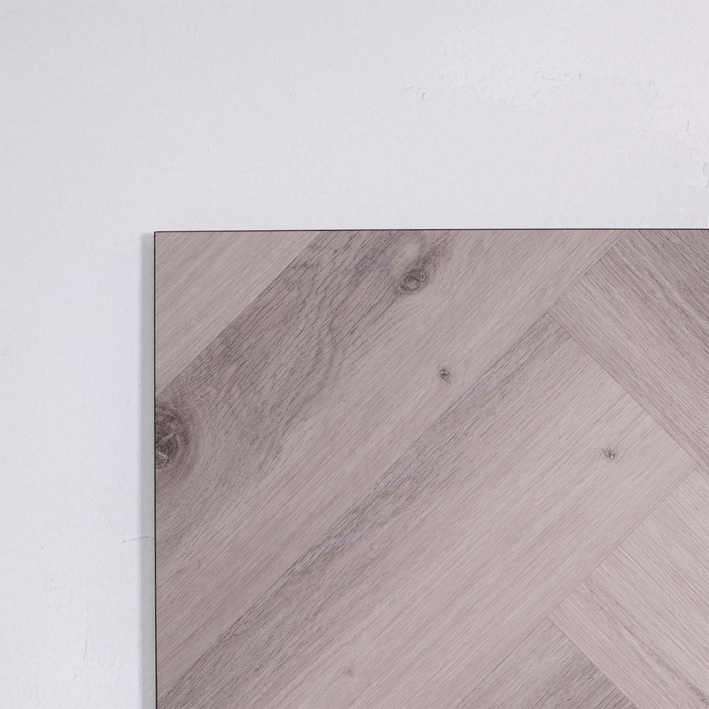 Side view of Snow Grey SPC Hybrid Floorboards Herringbone 7.5+2mm in Snow Grey colour light tone herringbone flooring sample