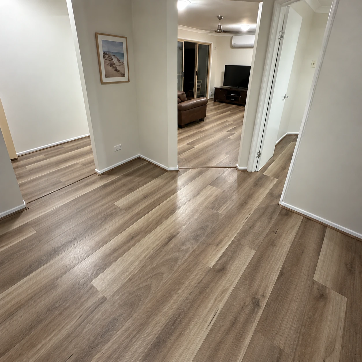 Natural Spotted Gum 9.5mm hybrid plank flooring in an Australian hallway living room
