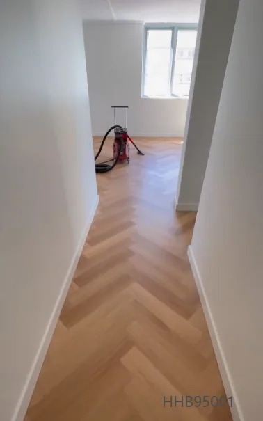 Natural Blackbutt 9.5mm herringbone hybrid flooring along a narrow hallway