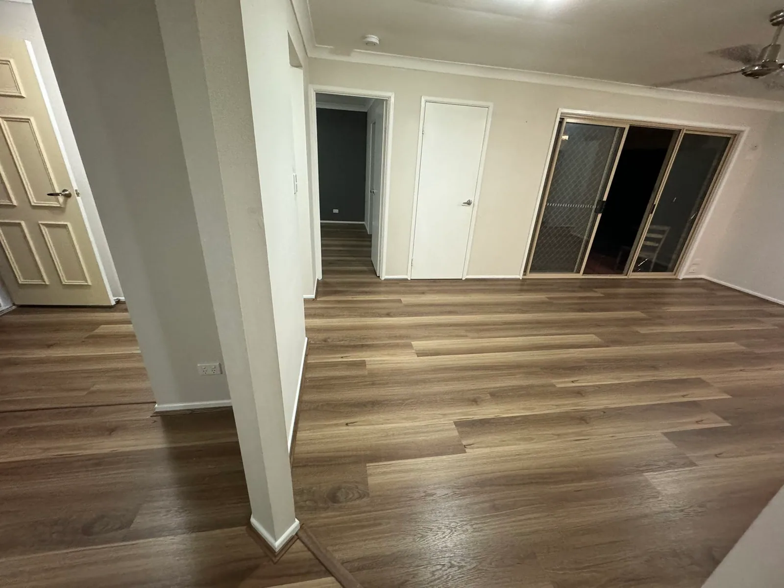 Natural Spotted Gum 9.5mm hybrid flooring at the top of stairs and adjoining rooms