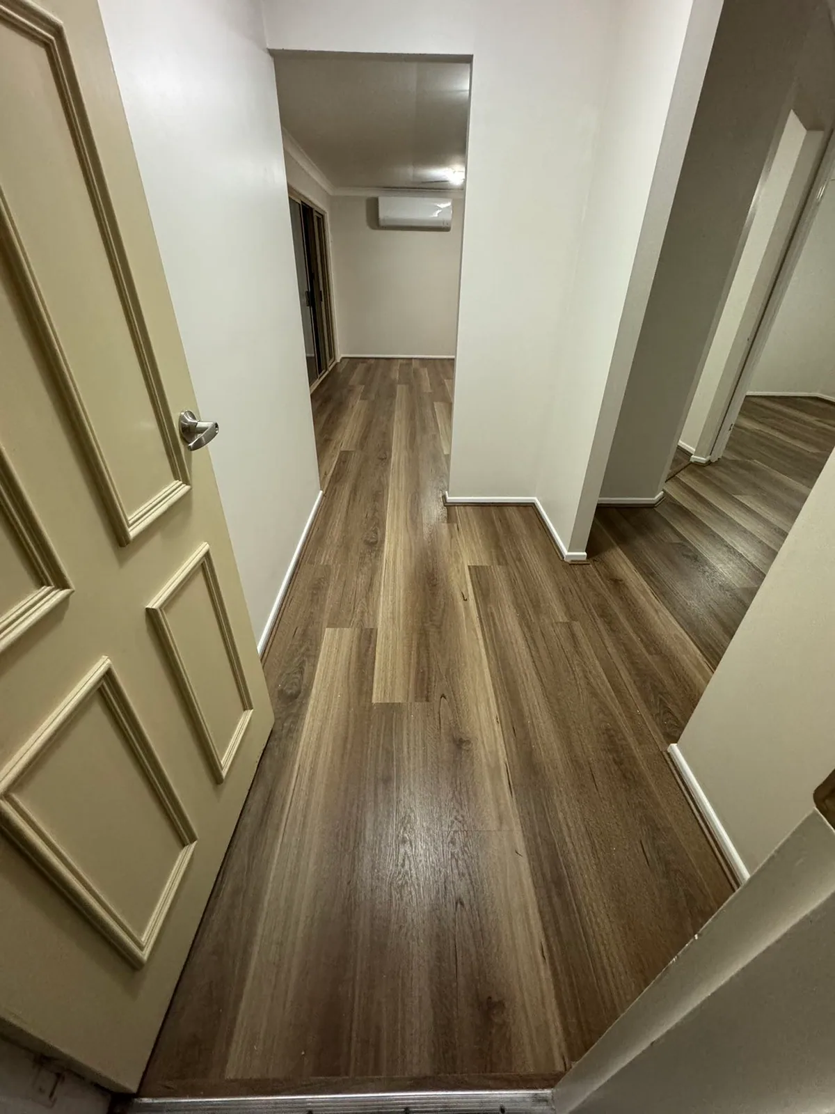 Natural Spotted Gum 9.5mm hybrid flooring along a narrow hallway