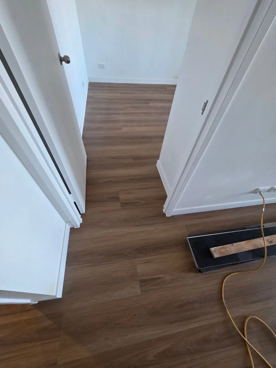 New England Blackbutt 9.5mm hybrid flooring through a doorway during installation